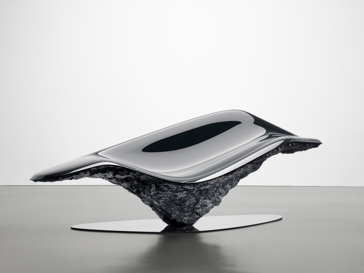 Pininfarina collectible bench, a mirror-polished steel seat resting on a raw textured base