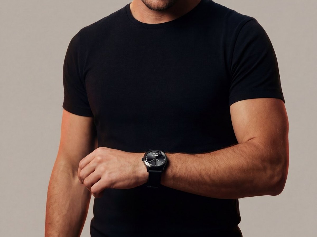 Man glancing at a black hybrid watch on his wrist