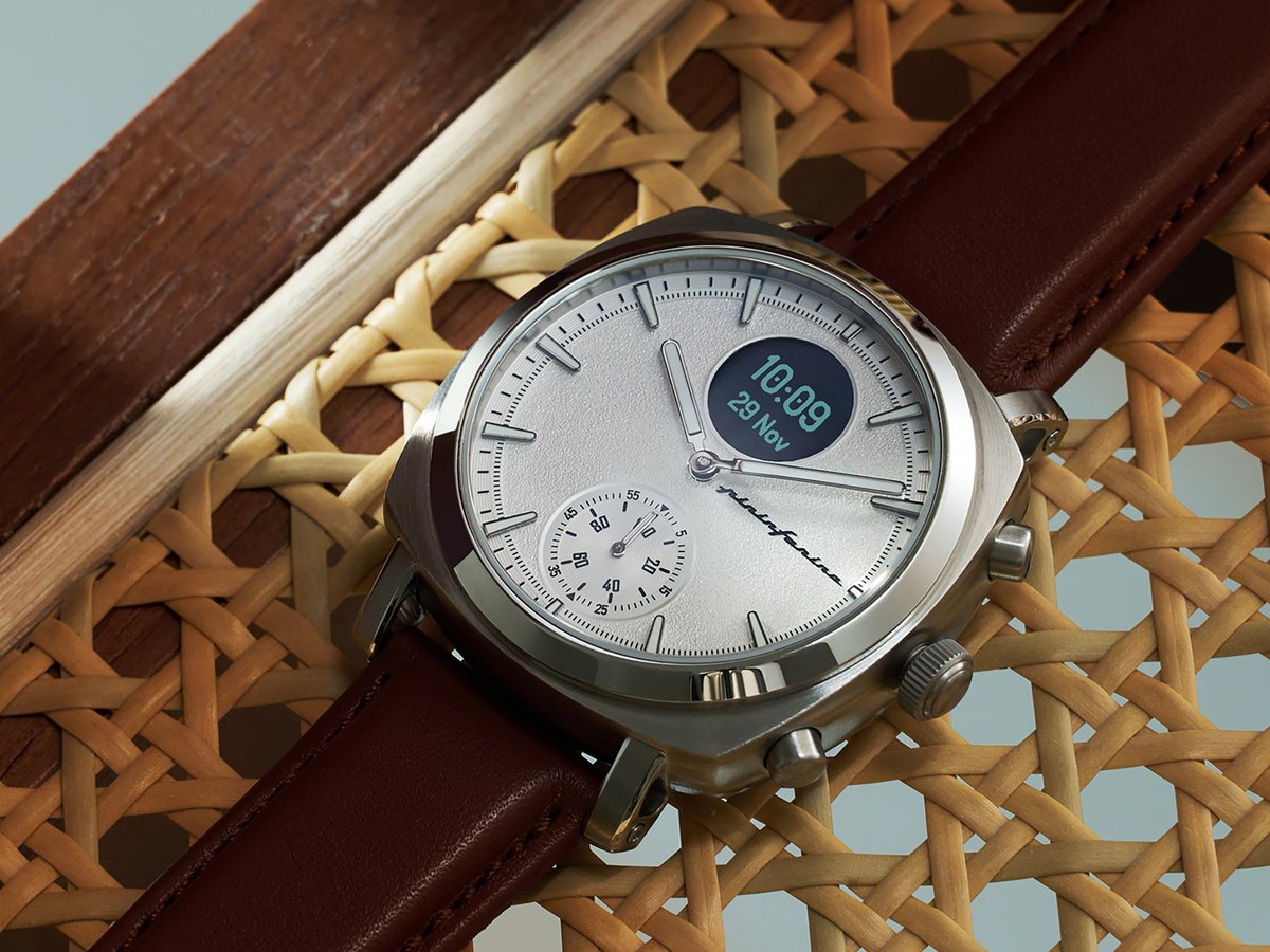 Detail of a hybrid watch with leather strap on woven rattan