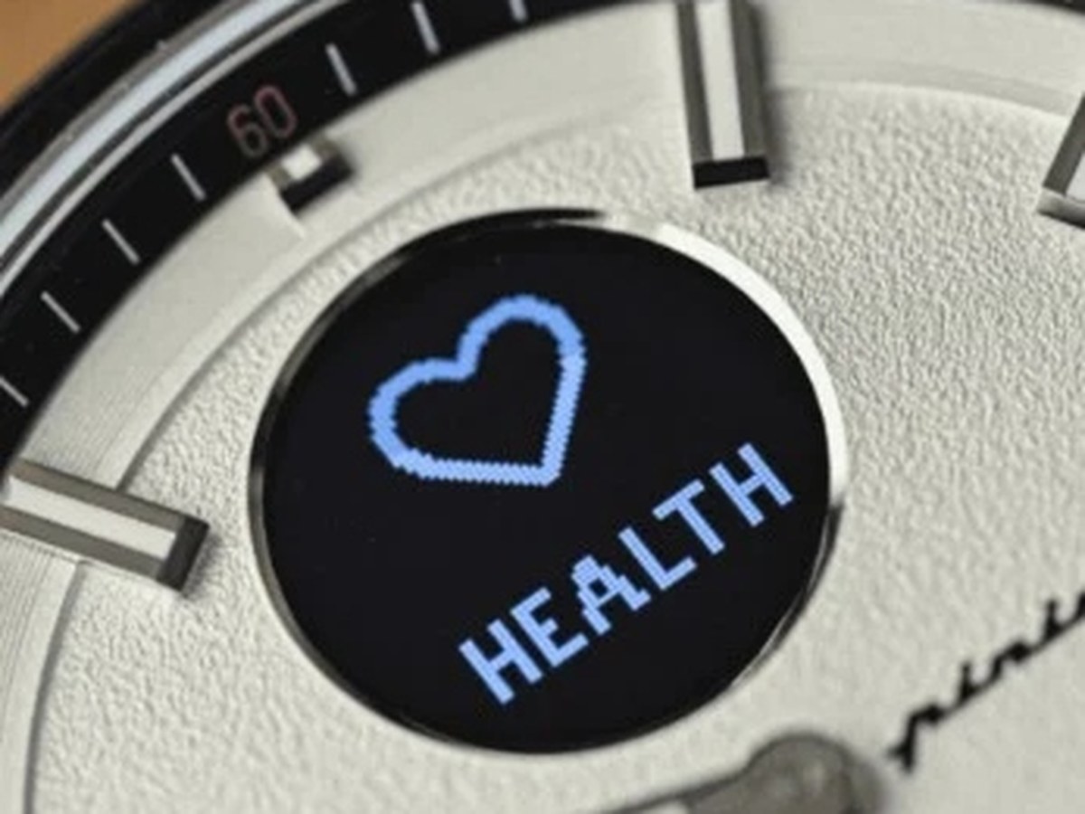Close-up of a hybrid watch dial with a health sub-display and a blue heart icon